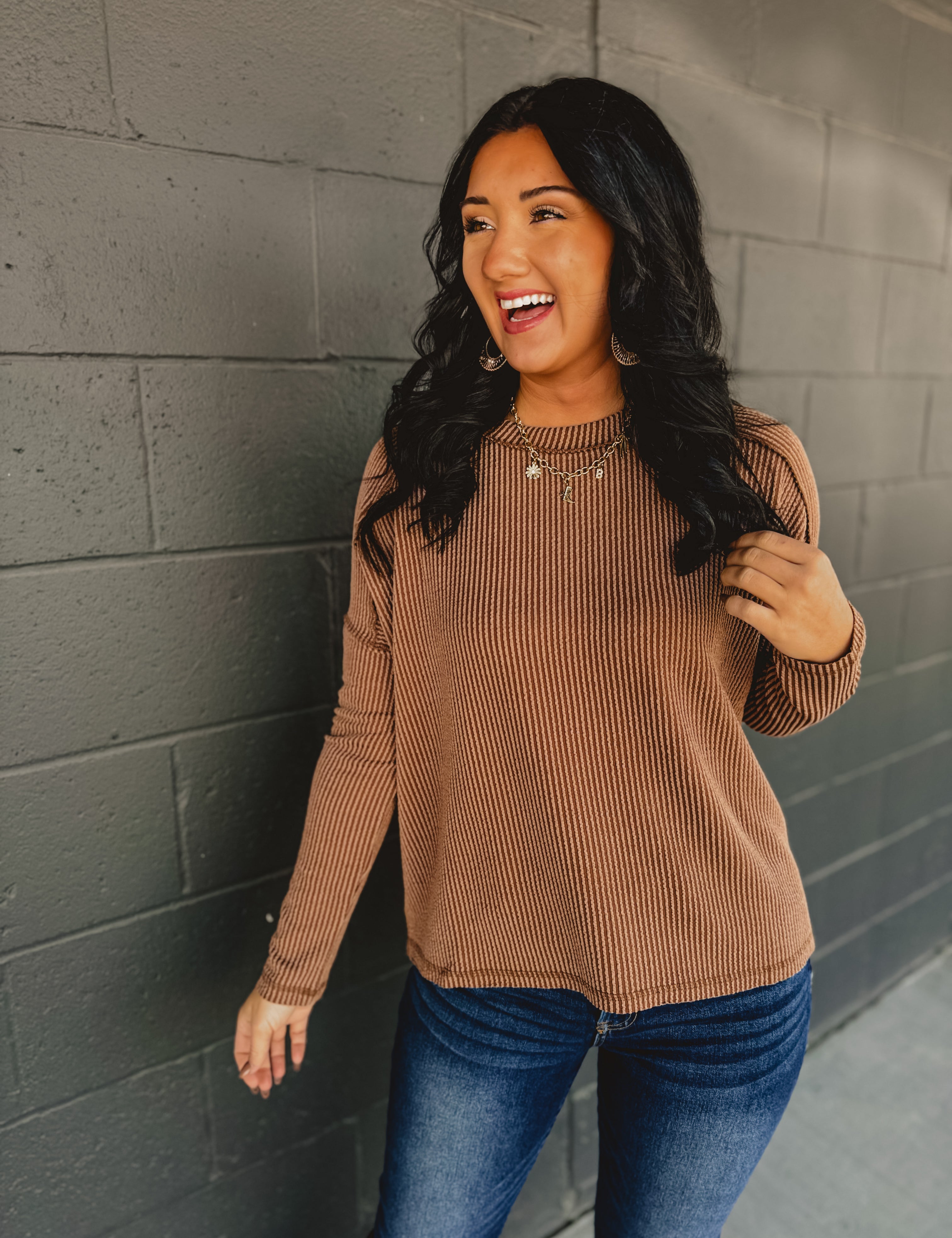 Ribbed raw edge long sleeve top in brown.