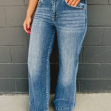 High rise two button wide stitched hem leg jean with front pockets and zip-up closure.