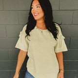 Gauze material oversized short sleeve top with ruched shoulders and bow ties in the color light sage.