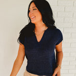 Split-neck short sleeve knit sweater top in the color navy.