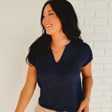 Split-neck short sleeve knit sweater top in the color navy.