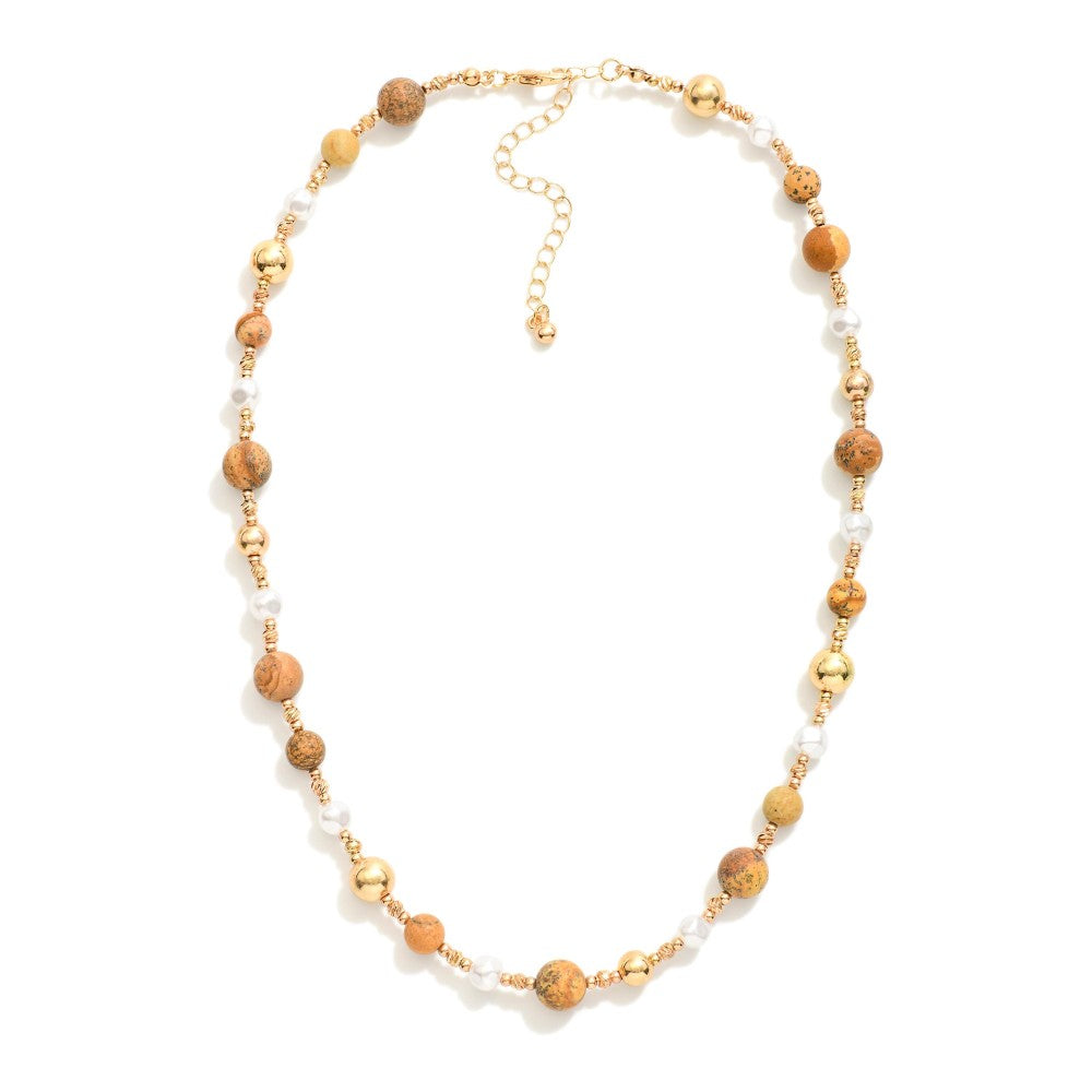 Brown hue stones, pearl, and gold beaded necklace with adjustable fit.