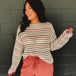 Open crochet boat neck long sleeve sweater with drop shoulders and stripes in multicolor.