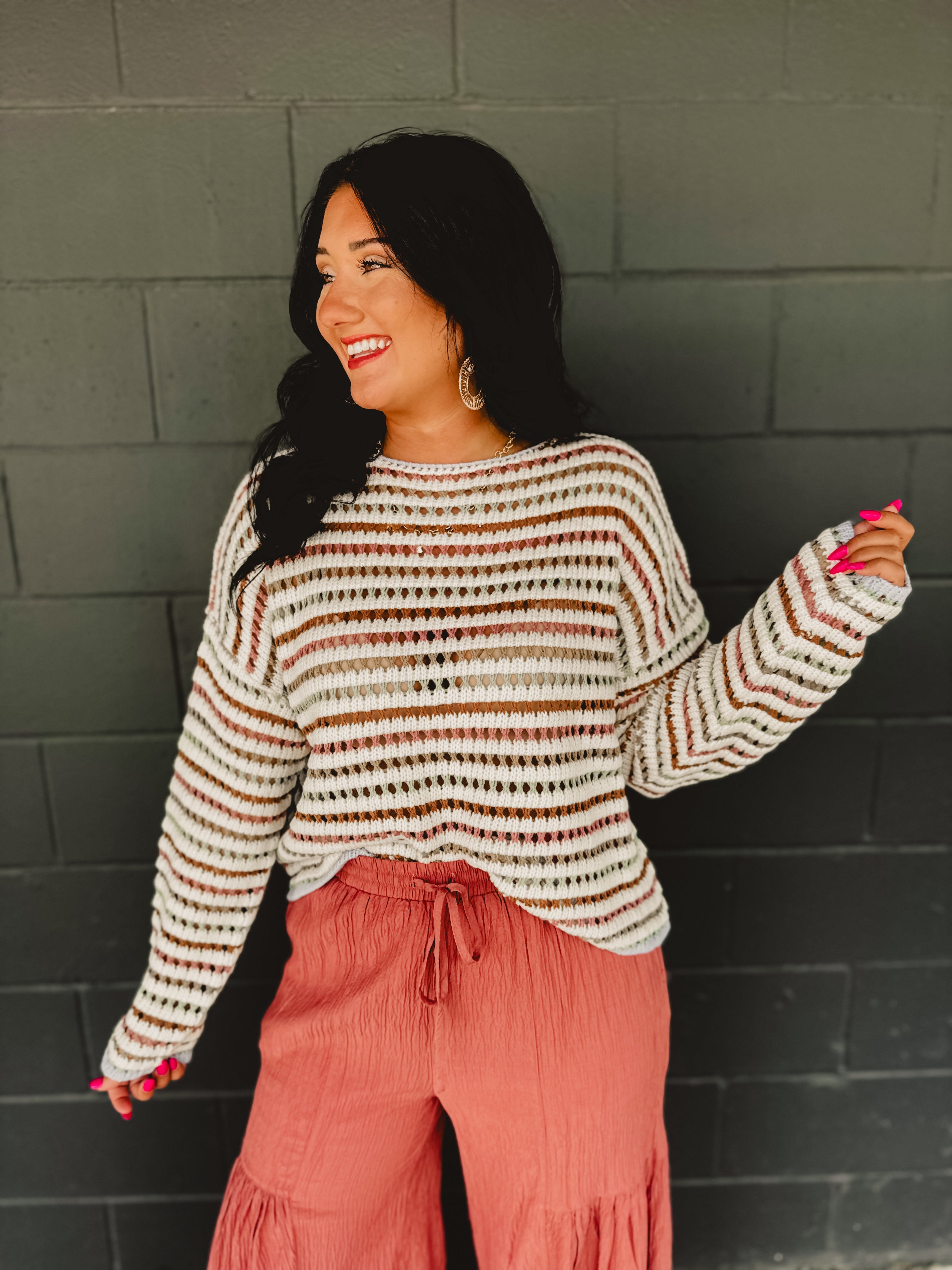 Open crochet boat neck long sleeve sweater with drop shoulders and stripes in multicolor.