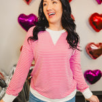 Striped drop shoulder pullover top with ribbed edges in pink.