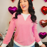 Striped drop shoulder pullover top with ribbed edges in pink.