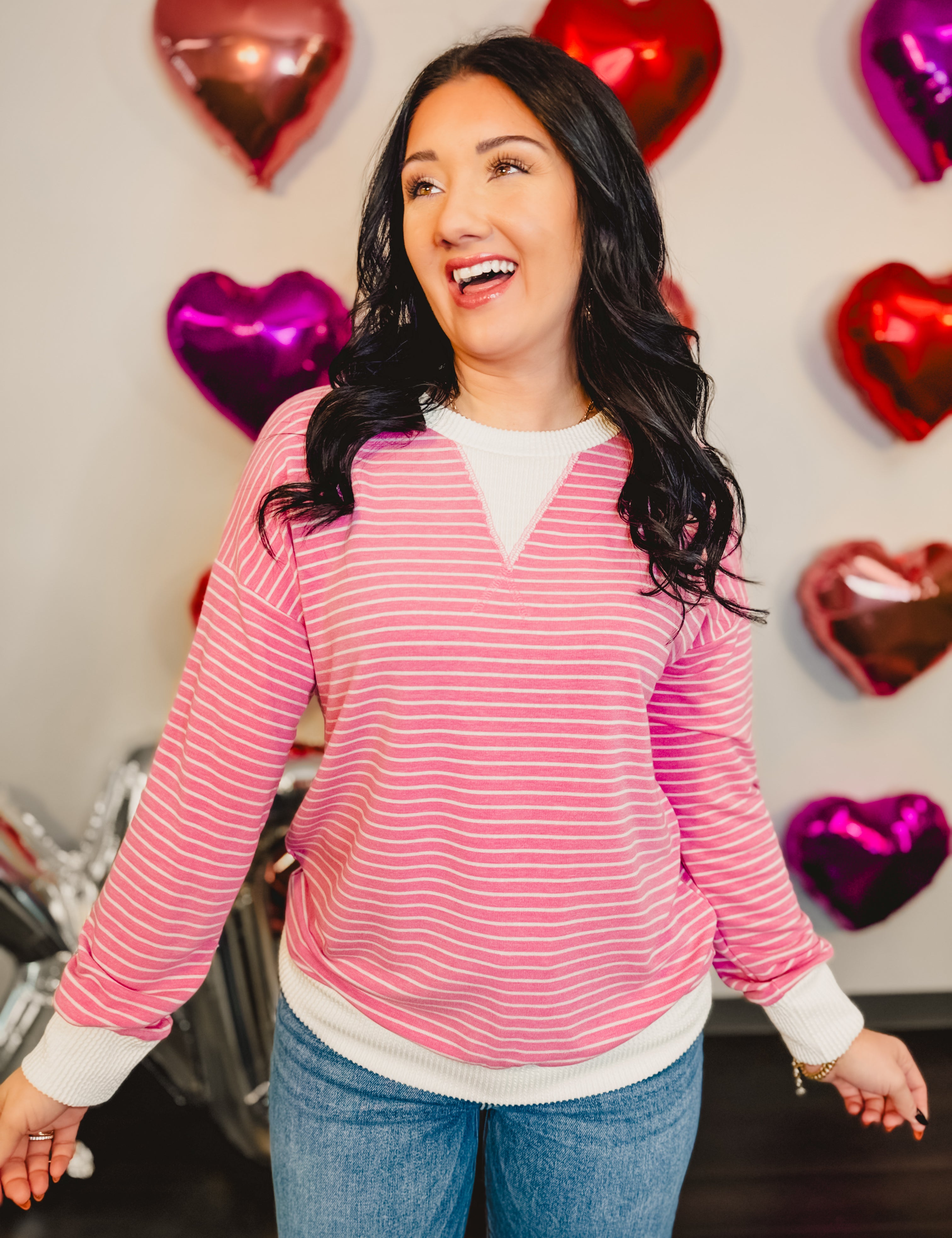 Striped drop shoulder pullover top with ribbed edges in pink.