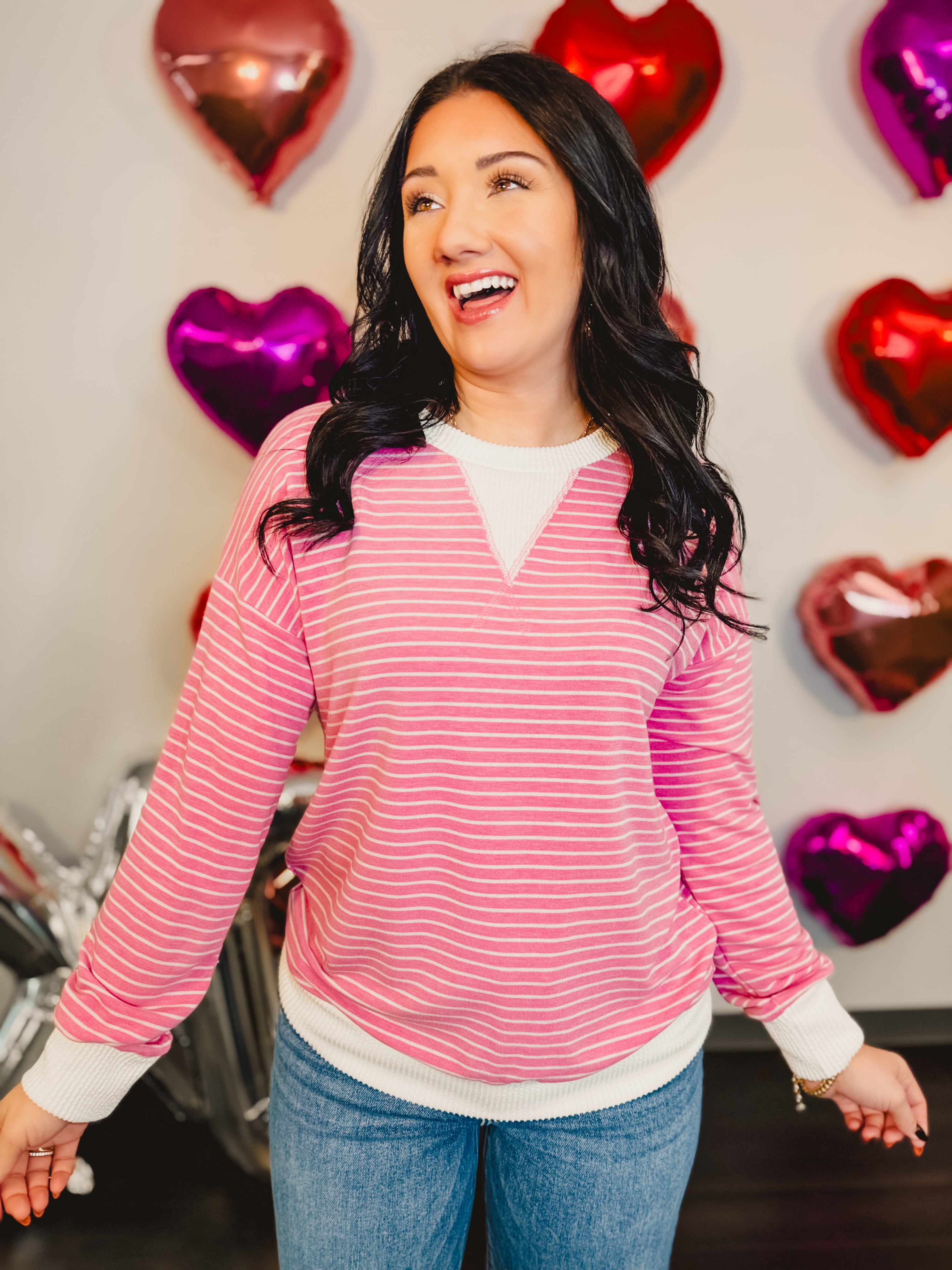 Striped drop shoulder pullover top with ribbed edges in pink.