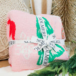 Super soft Christmas tree, bows, and snowflake decorated blanket in pink.