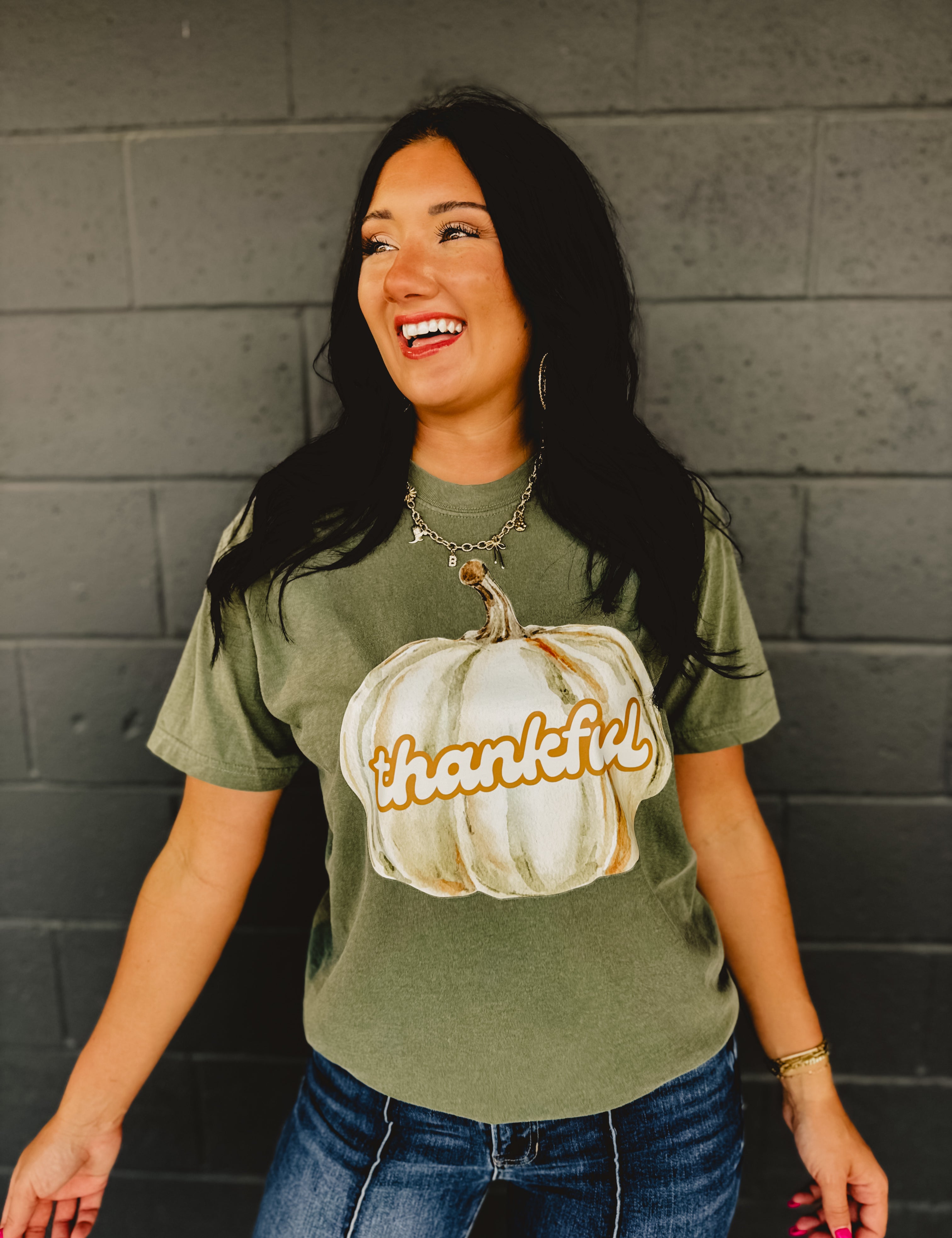 "Thankful" pumpkin autumn short sleeved graphic tee with a round neck and full length in moss green.