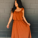 Rust colored bubble top and midi length skirt two piece set featuring side ties and flutter short sleeves.