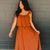 Rust colored bubble top and midi length skirt two piece set featuring side ties and flutter short sleeves.