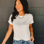 Rolled short sleeved round neck top in white.
