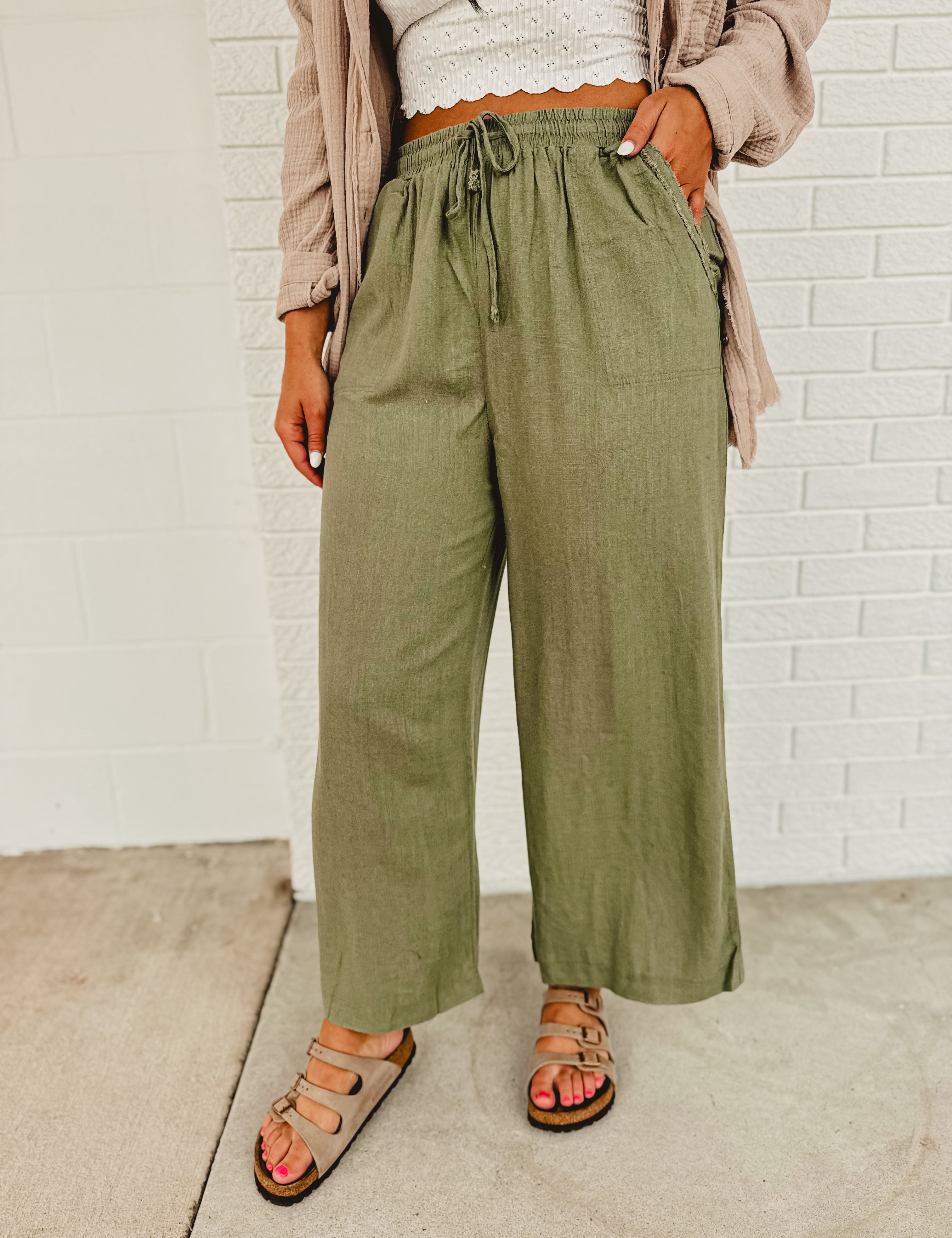 Linen drawstring wide leg pants with an elastic waistband and front pockets.