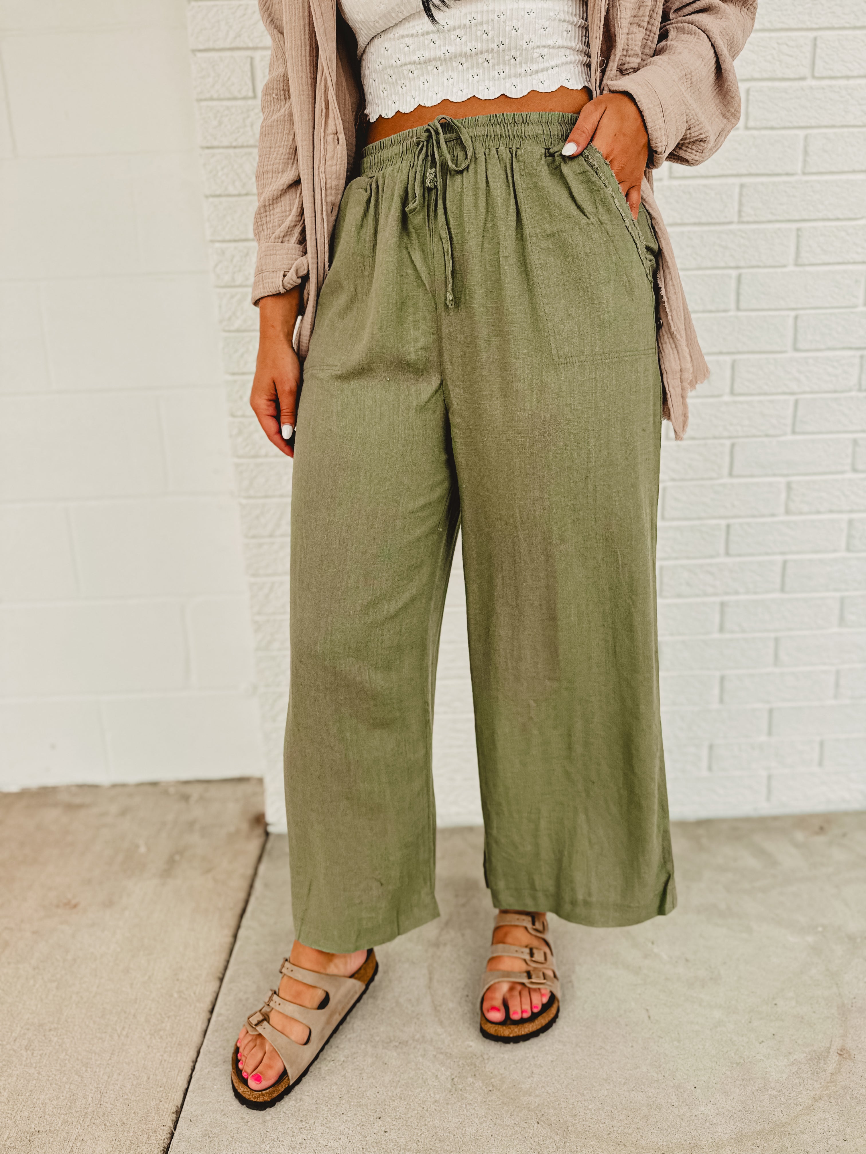 Linen drawstring wide leg pants with an elastic waistband and front pockets.