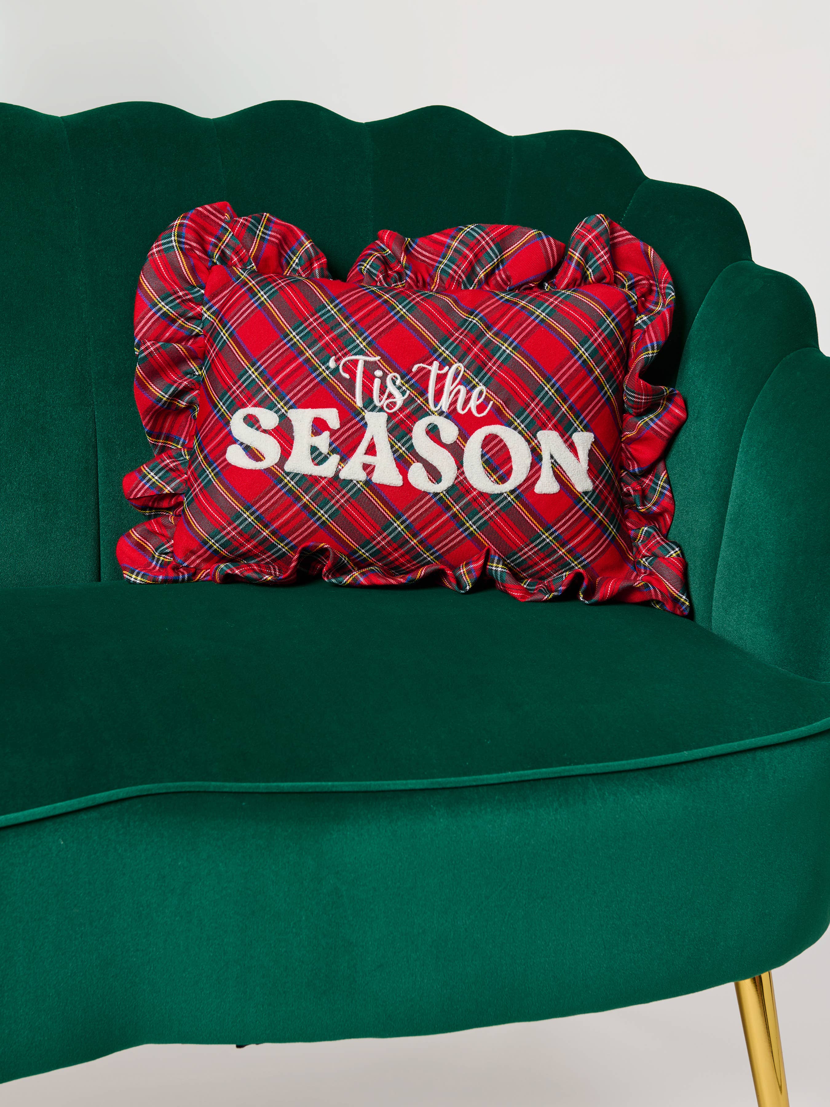 Tis the Season plaid ruffle pillow styled on a sofa